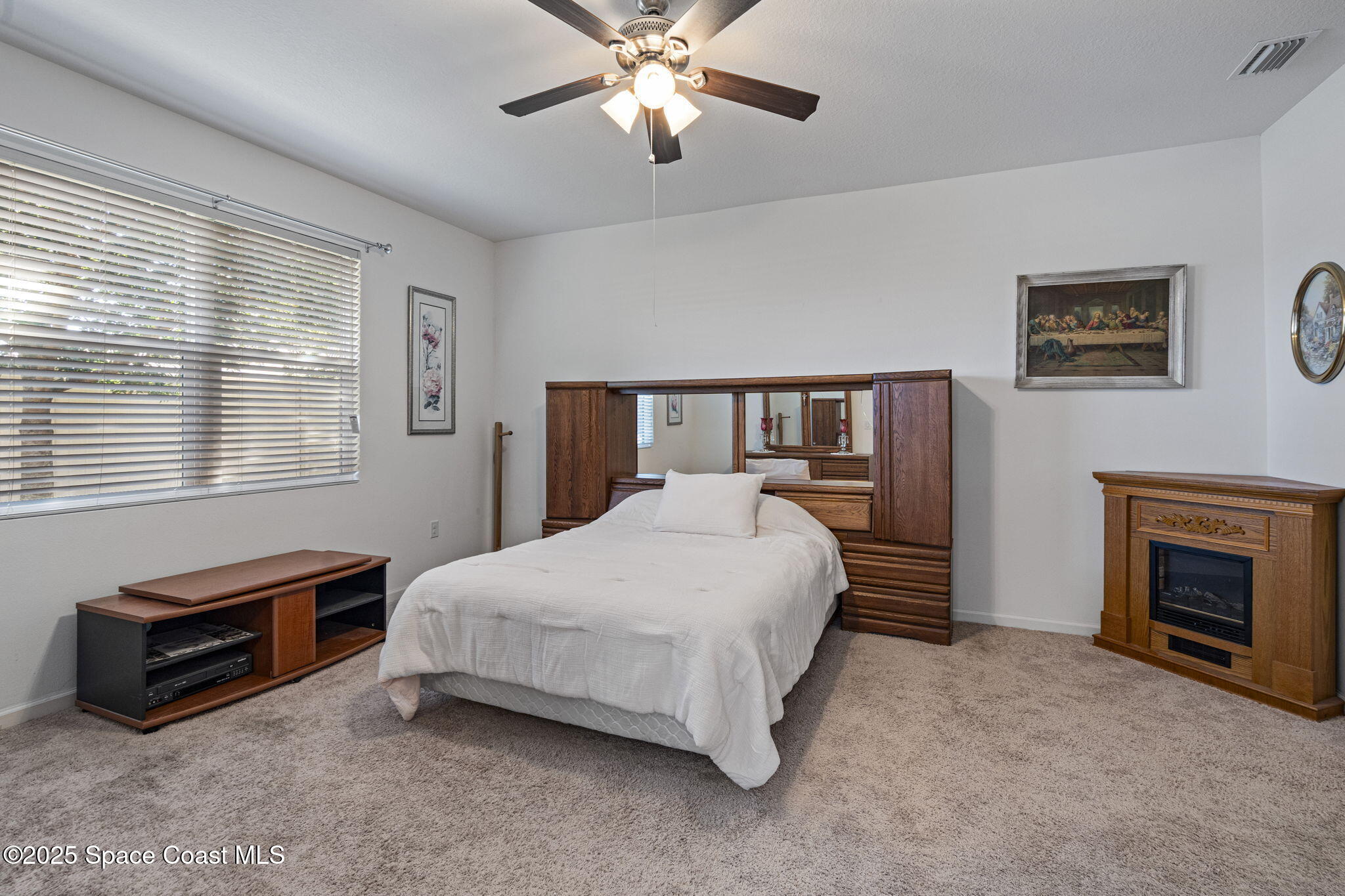 4015 Harvest Circle Rockledge, FL 32955 - Photo 27 of 40 a spacious bedroom with a bed and a chandelier