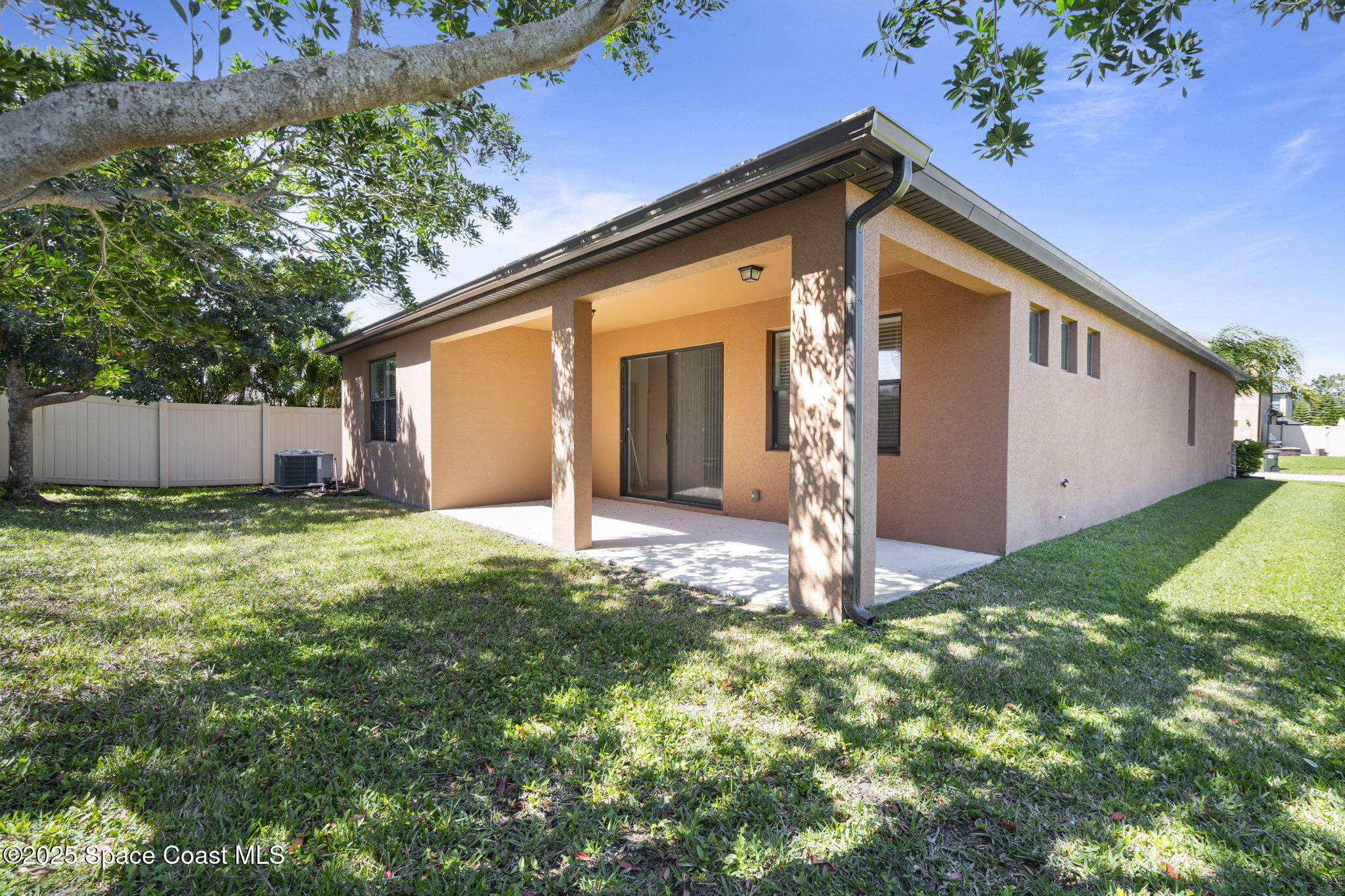 4015 Harvest Circle Rockledge, FL 32955 - Photo 38 of 40 a front view of a house with a yard and garage