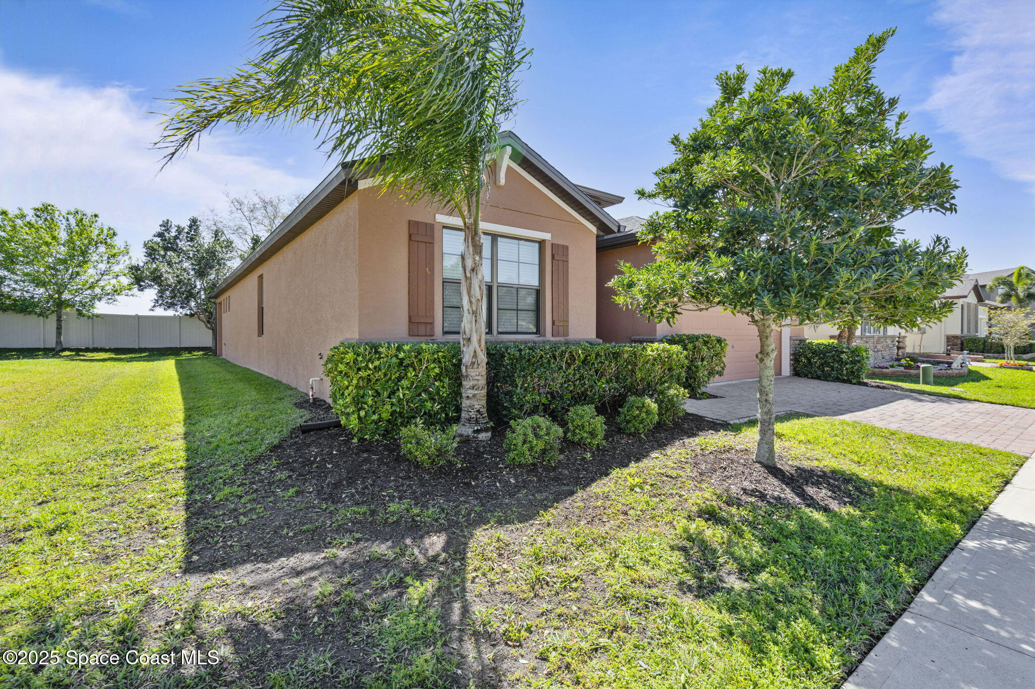 4015 Harvest Circle Rockledge, FL 32955 - Photo 4 of 40 a view of a backyard with plants and a patio