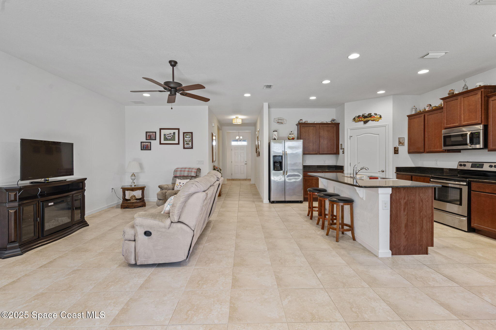 4015 Harvest Circle Rockledge, FL 32955 - Photo 5 of 40 a large kitchen with stainless steel appliances granite countertop a stove and a sink