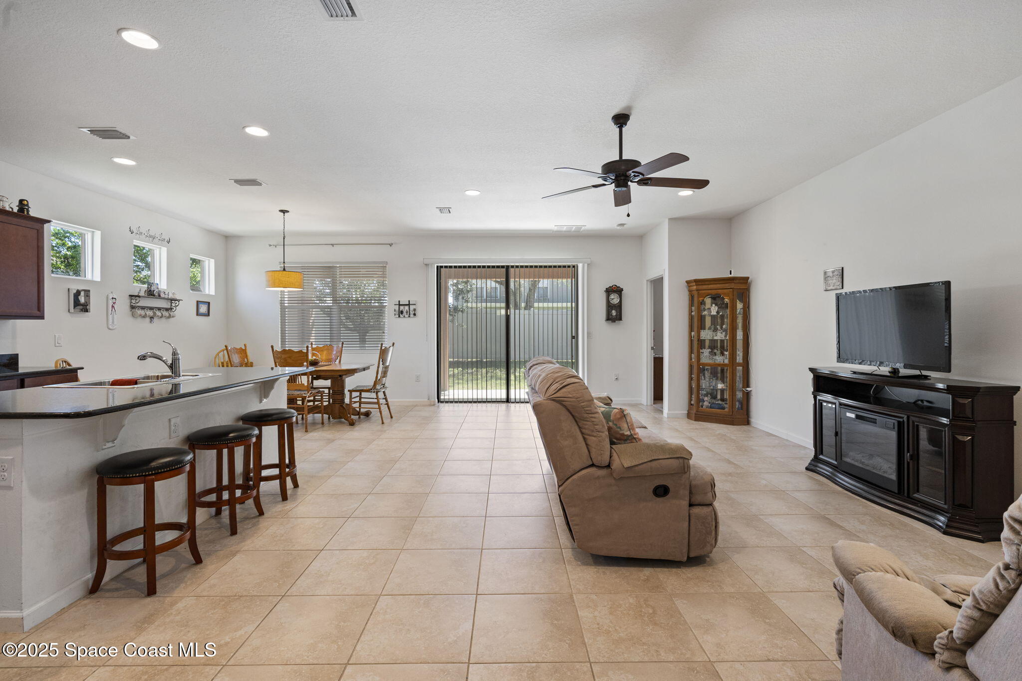 4015 Harvest Circle Rockledge, FL 32955 - Photo 6 of 40 a living room with furniture and a flat screen tv