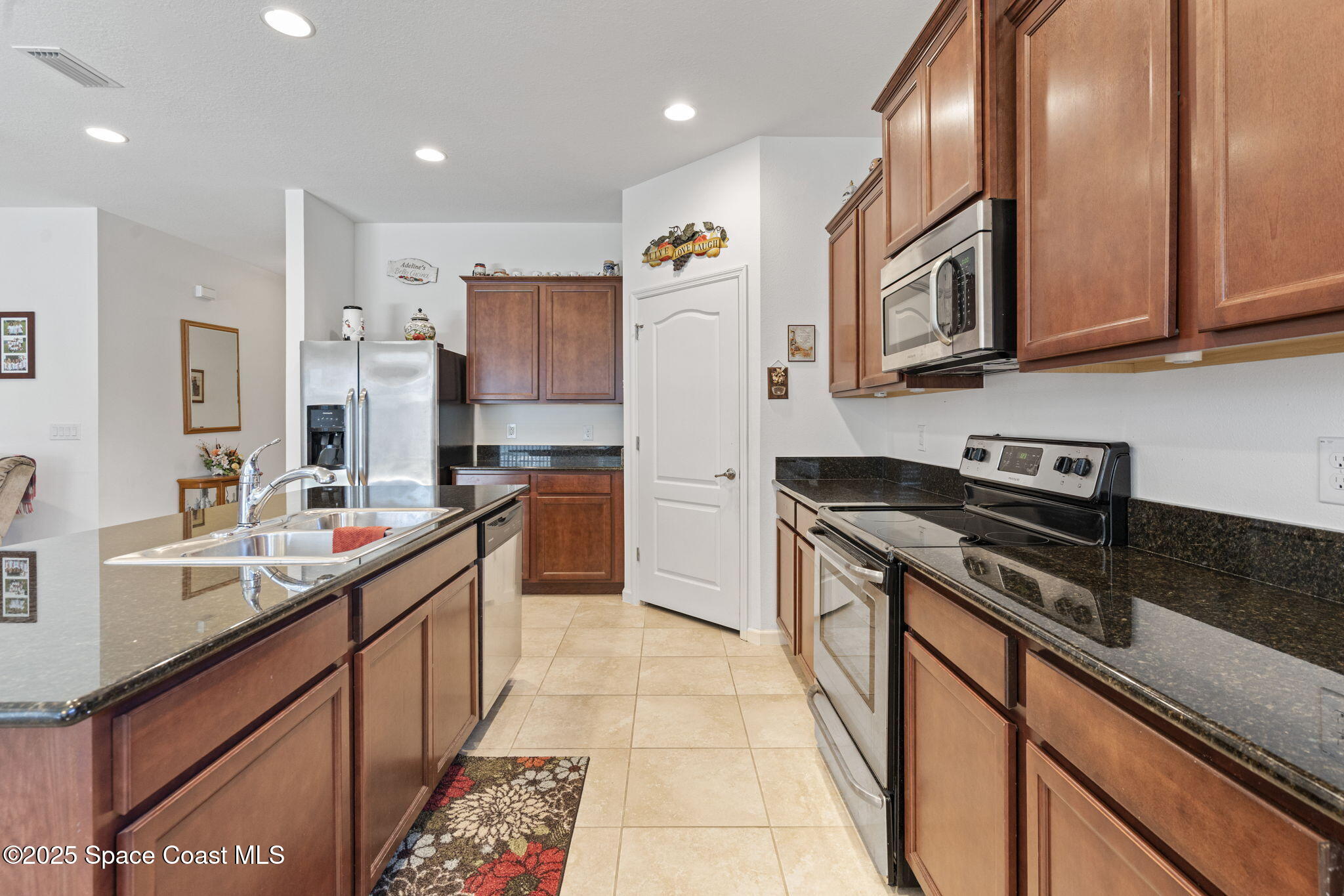 4015 Harvest Circle Rockledge, FL 32955 - Photo 9 of 40 a kitchen with stainless steel appliances granite countertop a sink and cabinets