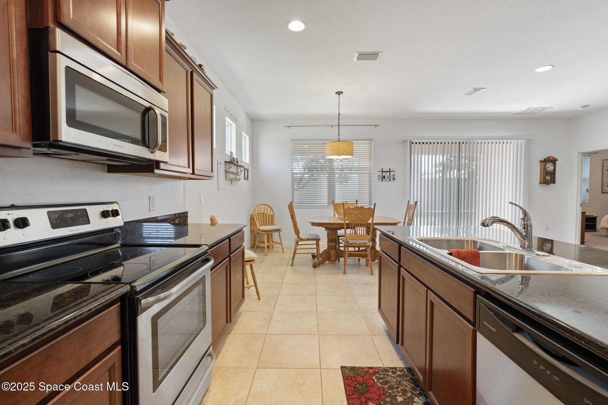 4015 Harvest Circle Rockledge, FL 32955 - Photo 10 of 40 a kitchen with a sink stove and microwave