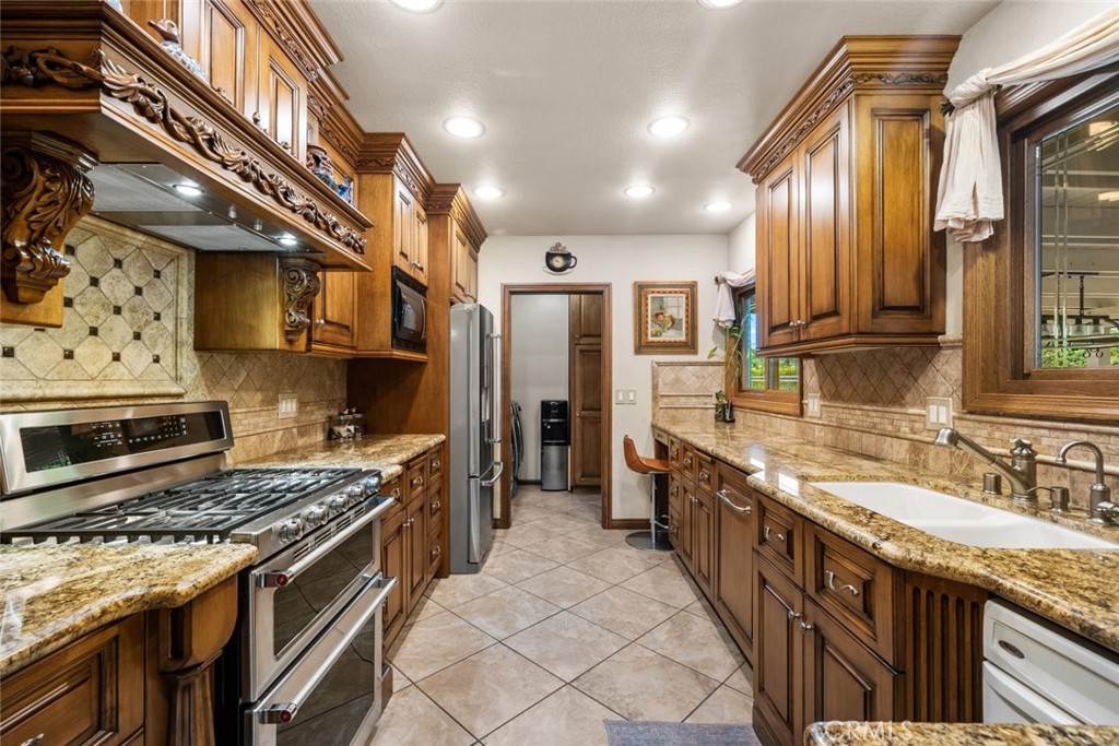 924 Crestview Drive Pasadena, CA 91107 - Photo 13 of 33 a kitchen with stainless steel appliances granite countertop a stove a sink and a refrigerator