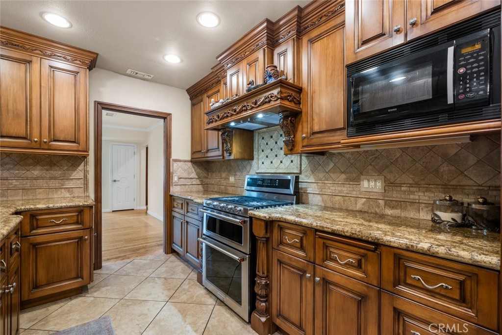 924 Crestview Drive Pasadena, CA 91107 - Photo 15 of 33 a kitchen with stainless steel appliances granite countertop a stove microwave and cabinets