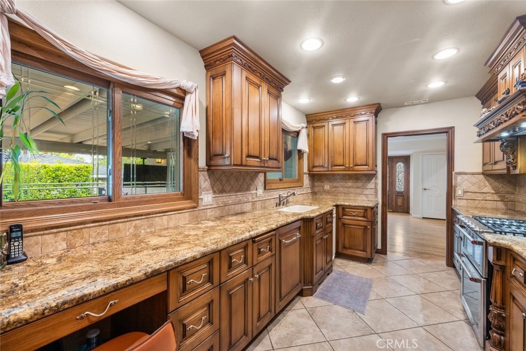 924 Crestview Drive Pasadena, CA 91107 - Photo 16 of 33 a large kitchen with granite countertop a sink and cabinets