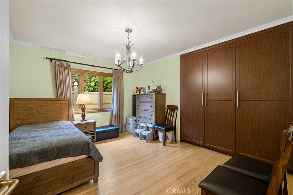 924 Crestview Drive Pasadena, CA 91107 - Photo 22 of 33 a bedroom with a bed and a chandelier