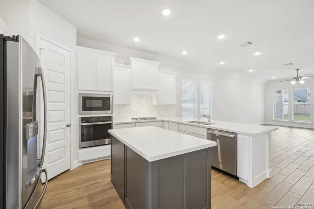 a kitchen with a sink stove and refrigerator