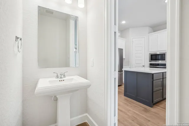 a bathroom with a sink a mirror and a toilet