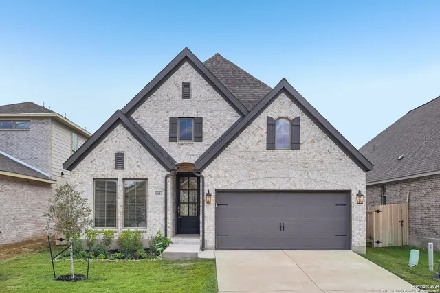 a front view of a house with a yard