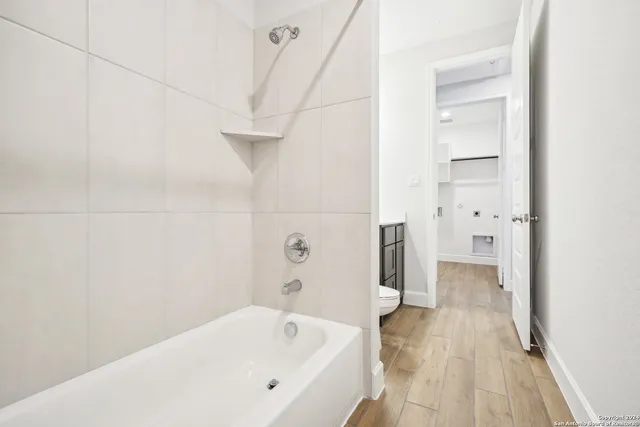 a bathroom with a bathtub and shower