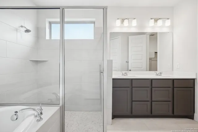 a bathroom with a tub sink and mirror
