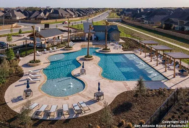 a view of a swimming pool with outdoor seating