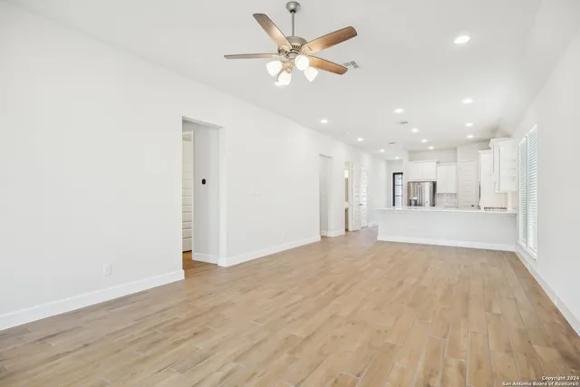 a view of an empty room with a kitchen