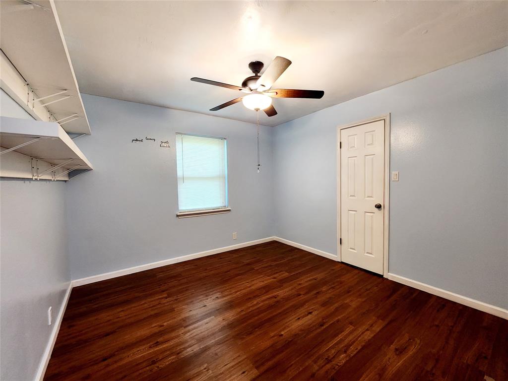 3514 Buchanan Loop Road Texarkana, TX 75501 - Photo 13 of 40 a view of an empty room with wooden floor and a ceiling fan
