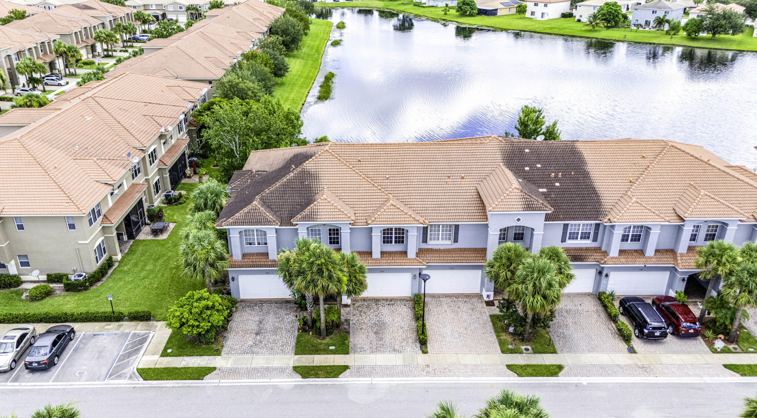 an aerial view of a house with garden space and lake view
