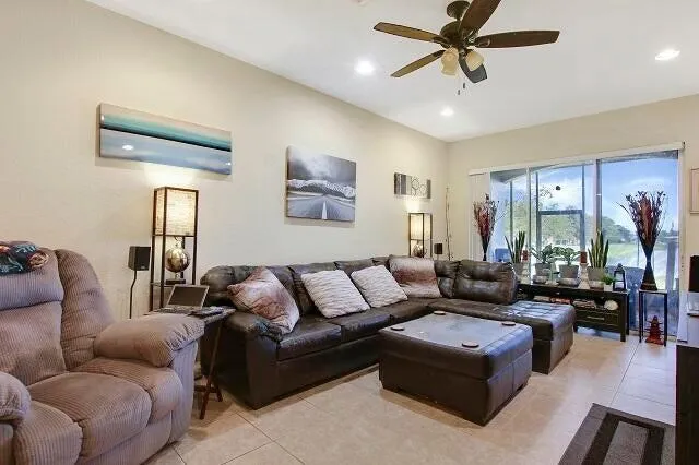 a bedroom with a bed a large window and flat screen tv