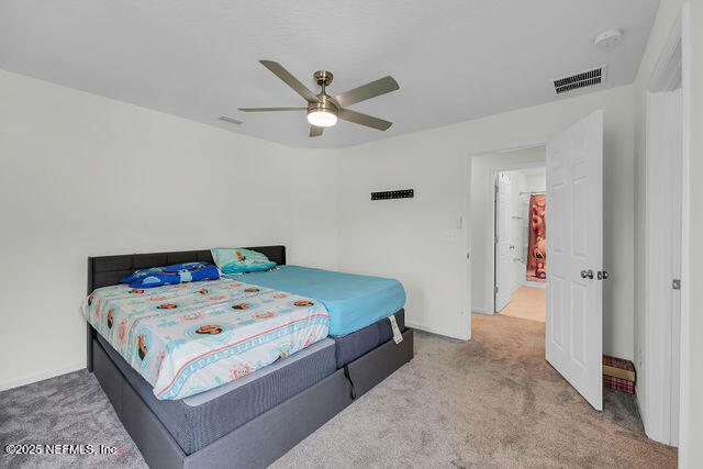 136 Peace River Road St. Johns, FL 32259 - Photo 19 of 52 a bedroom with a bed and a chandelier