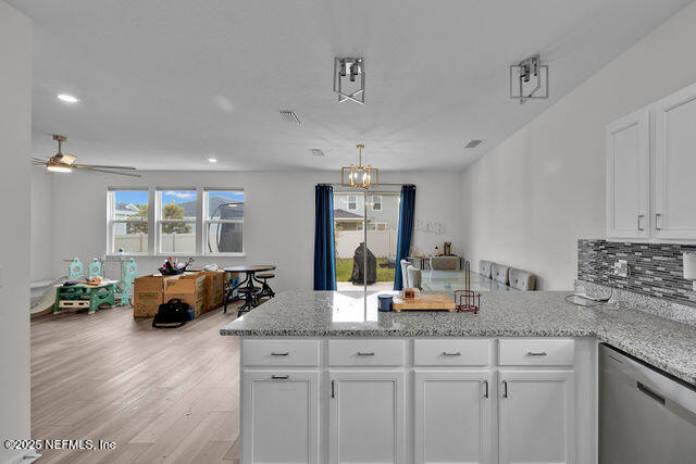 136 Peace River Road St. Johns, FL 32259 - Photo 35 of 52 a kitchen with granite countertop a sink a counter top space and living room