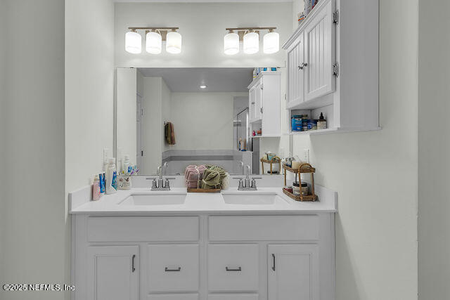 136 Peace River Road St. Johns, FL 32259 - Photo 45 of 52 a bathroom with cabinets sink and a mirror