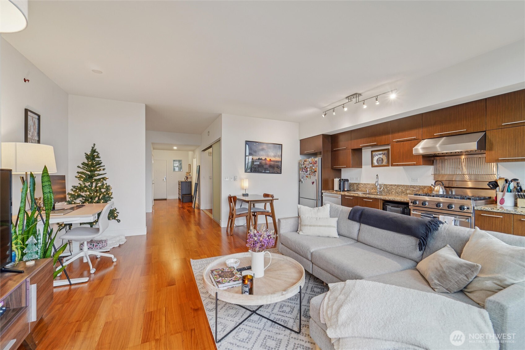 2911 2nd Avenue, Unit 818 Seattle, WA 98121 - Photo 13 of 15 a living room with furniture and wooden floor
