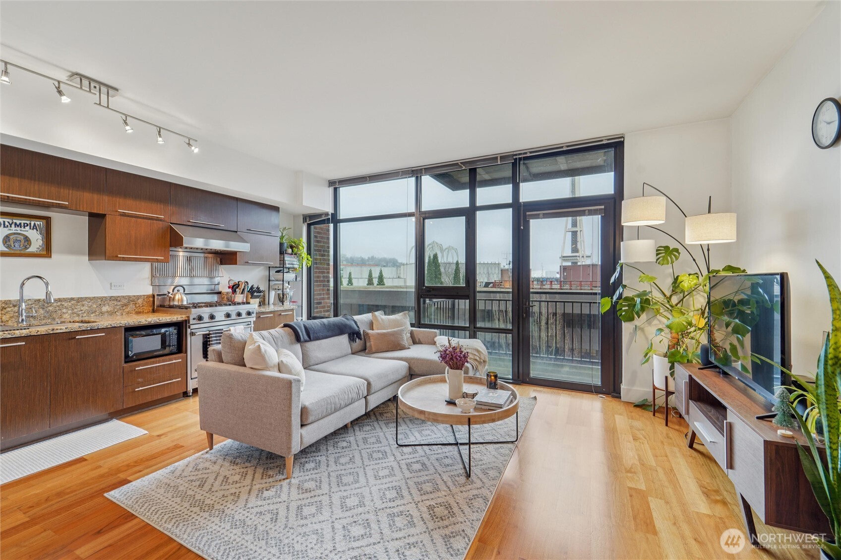 2911 2nd Avenue, Unit 818 Seattle, WA 98121 - Photo 5 of 15 a living room with furniture and a flat screen tv
