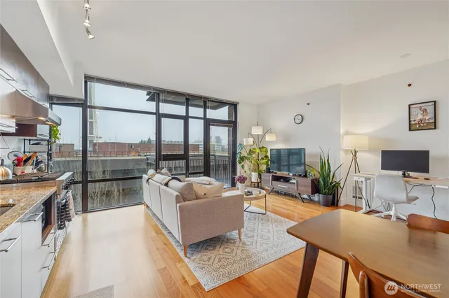 a living room with furniture large window and a table