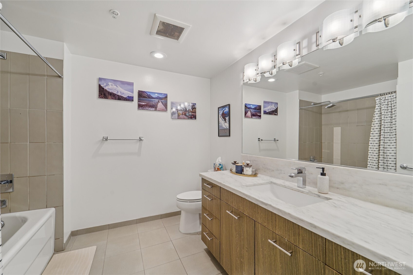 2911 2nd Avenue, Unit 818 Seattle, WA 98121 - Photo 10 of 15 a bathroom with a double vanity sink mirror and toilet