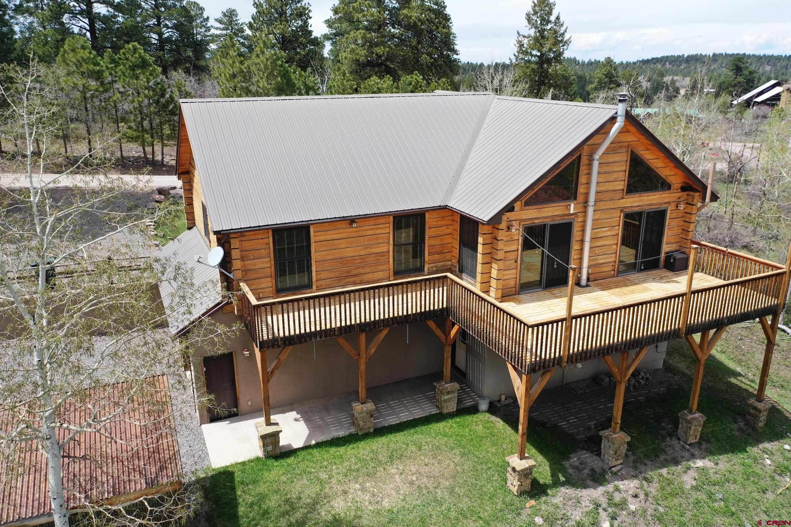 1480 Aspen Drive Ridgway, CO 81432 - Photo 1 of 1 a view of house with roof deck and garden