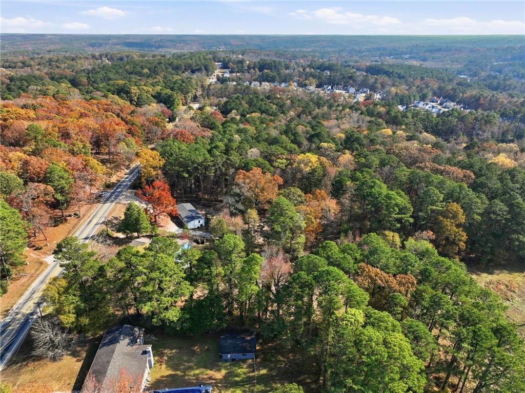 7411 Pleasant Hill Road Lithonia, GA 30058 - Photo 11 of 15 an aerial view of residential house with outdoor space and trees all around
