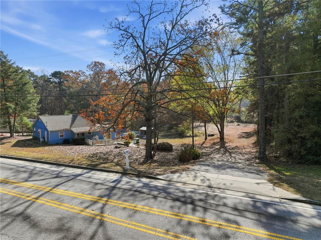 7411 Pleasant Hill Road Lithonia, GA 30058 - Photo 2 of 15 a view of road with large trees