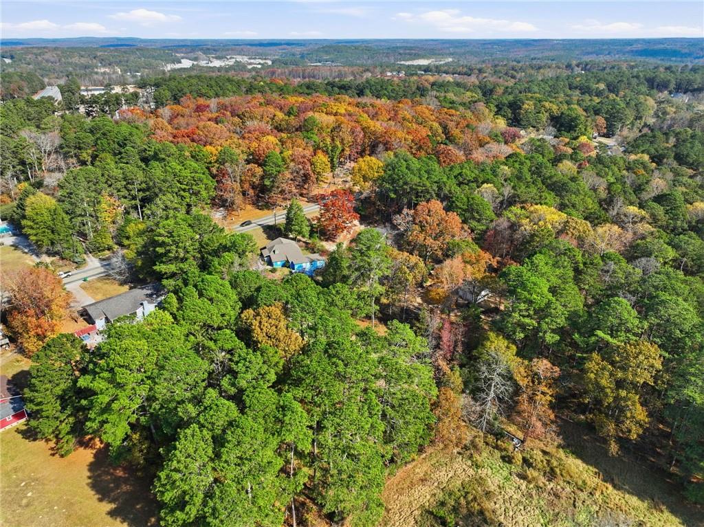 7411 Pleasant Hill Road Lithonia, GA 30058 - Photo 10 of 15 an aerial view of residential houses with outdoor space and trees