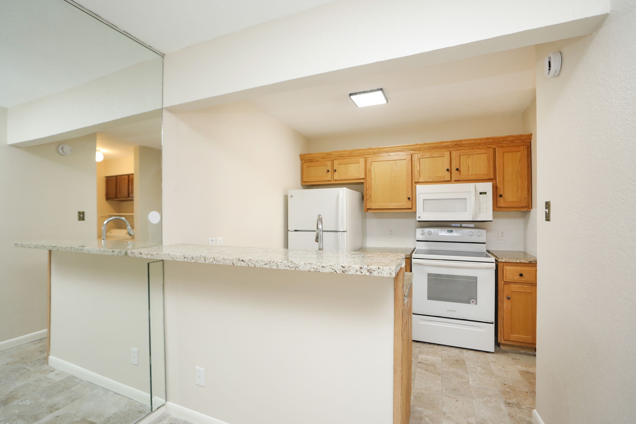 17401 Red Oak Drive, Unit 97 Houston, TX 77090 - Photo 11 of 37 a kitchen with stainless steel appliances granite countertop a sink and cabinets