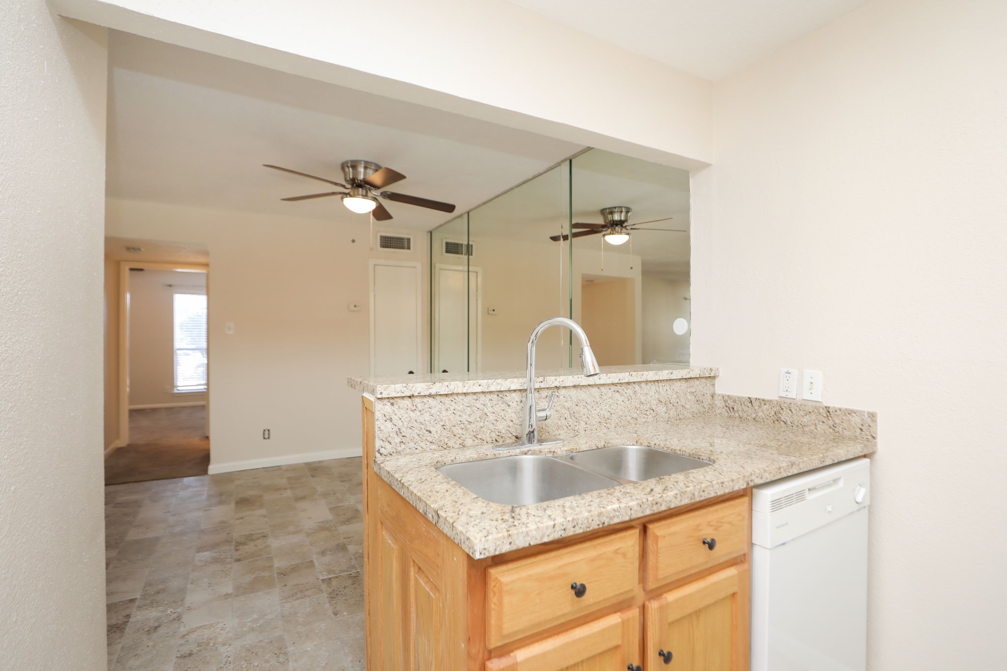 17401 Red Oak Drive, Unit 97 Houston, TX 77090 - Photo 15 of 37 a bathroom with a granite countertop sink a mirror and shower