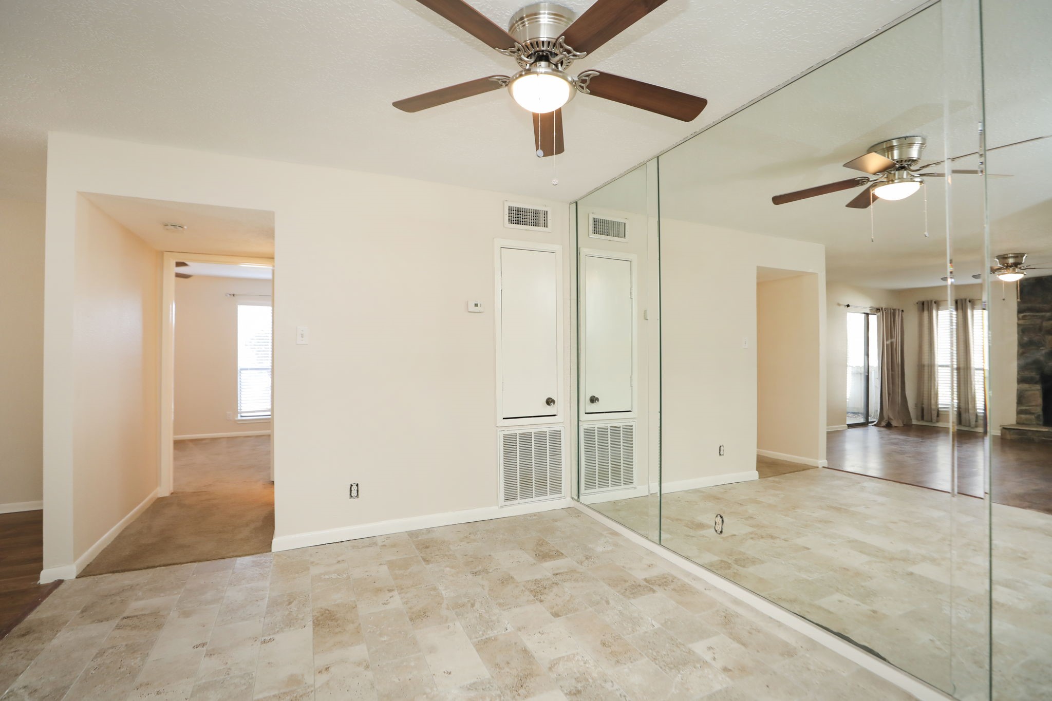 17401 Red Oak Drive, Unit 97 Houston, TX 77090 - Photo 19 of 37 a view of a livingroom with a chandelier fan and a ceiling fan