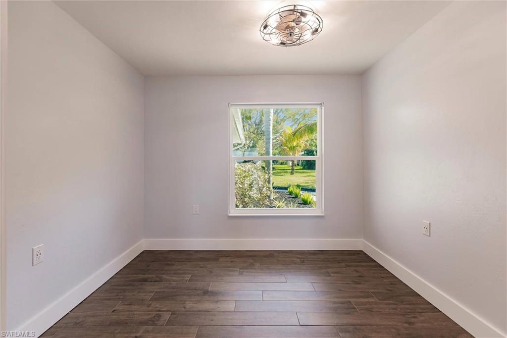 138 Riverview Road Fort Myers, FL 33905 - Photo 36 of 50 Empty room with dark wood-style floors and baseboards
