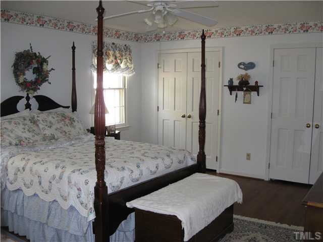 1105 Country Ridge Drive Raleigh, NC 27609 - Photo 10 of 12 Large Secondary Bedroom with Ceiling Fan, Dual Closets, and Hardwood Floors Bedroom