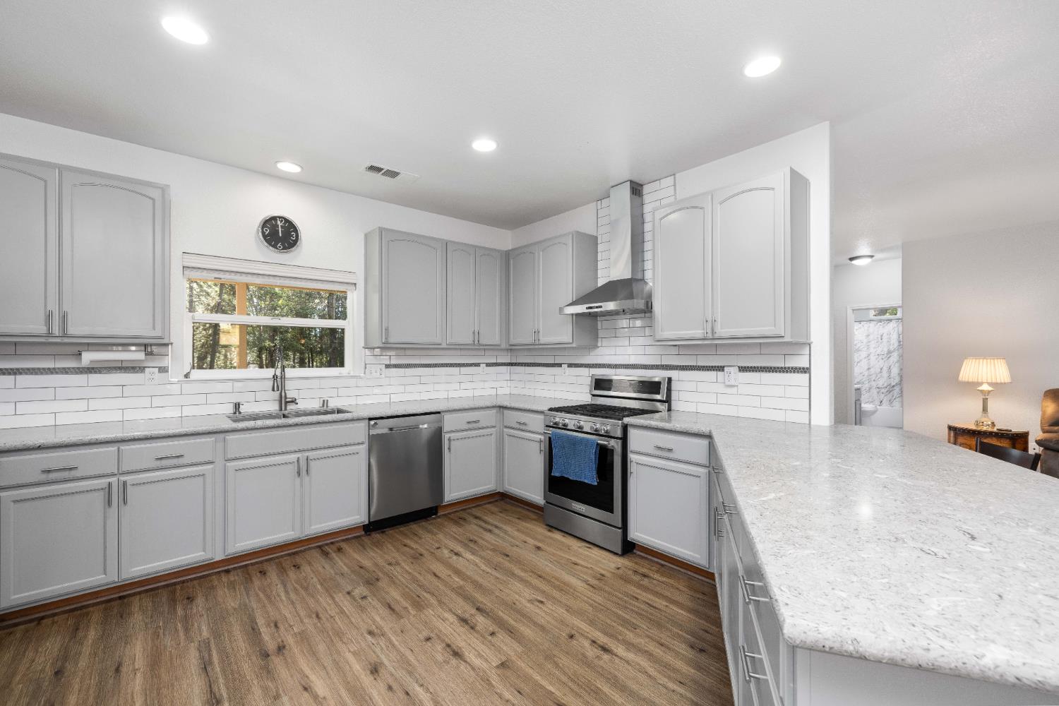 6843 Log Cabin Lane Placerville, CA 95667 - Photo 20 of 49 a large kitchen with cabinets wooden floor and stainless steel appliances