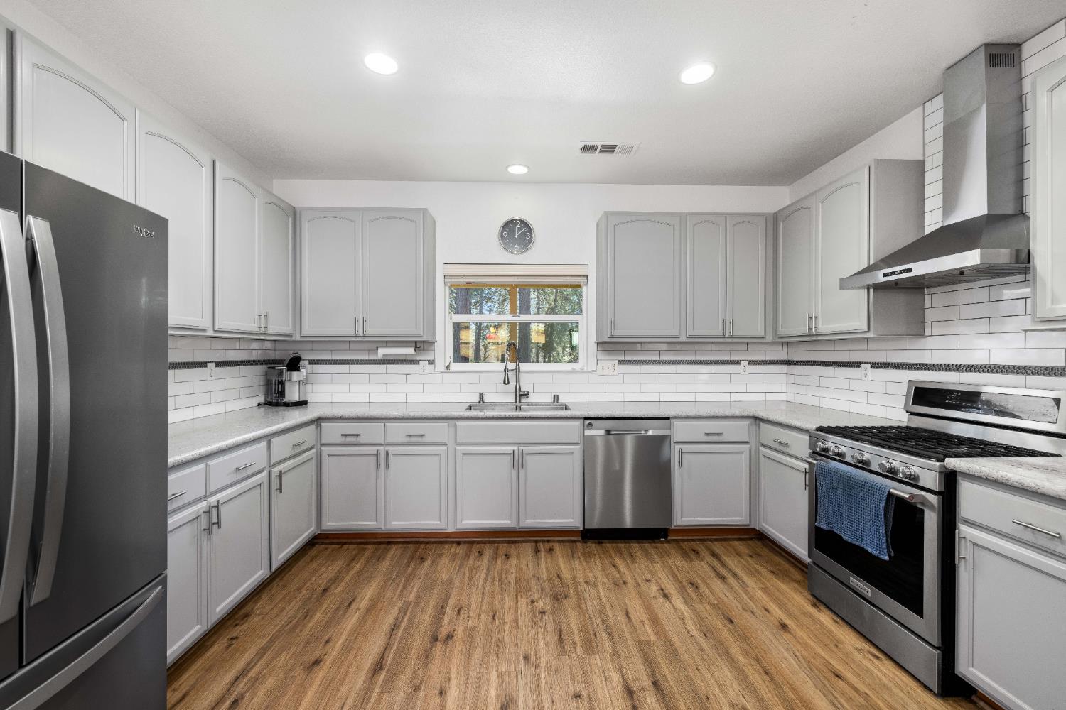 6843 Log Cabin Lane Placerville, CA 95667 - Photo 2 of 49 a kitchen with granite countertop stainless steel appliances a sink cabinets and a window