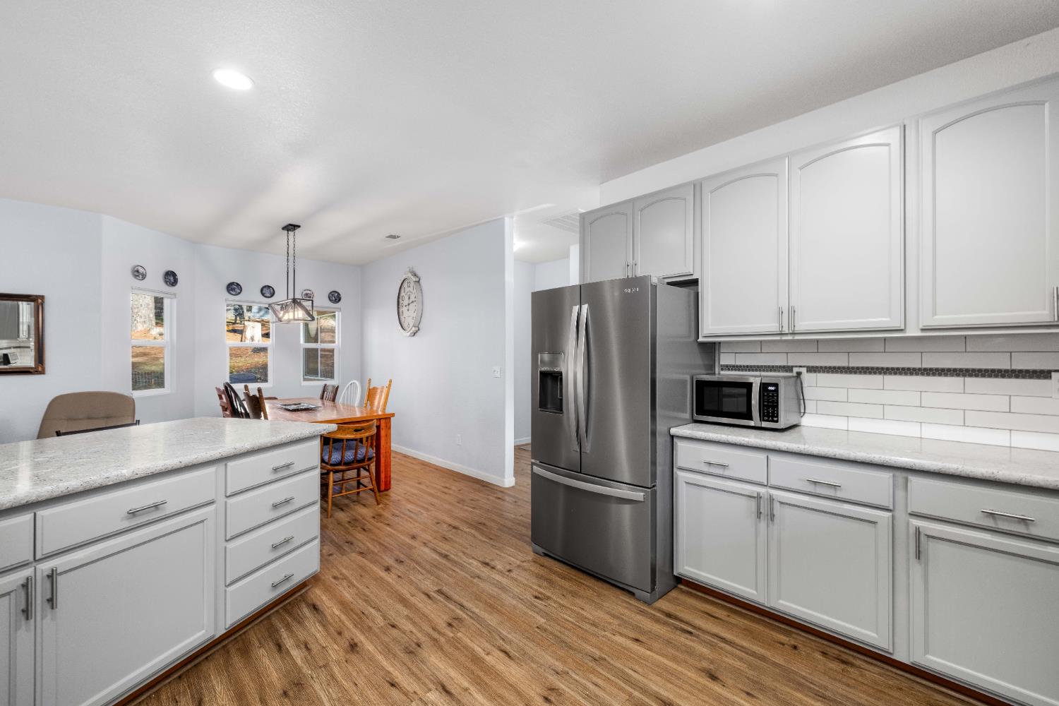 6843 Log Cabin Lane Placerville, CA 95667 - Photo 24 of 49 a kitchen with white cabinets and stainless steel appliances