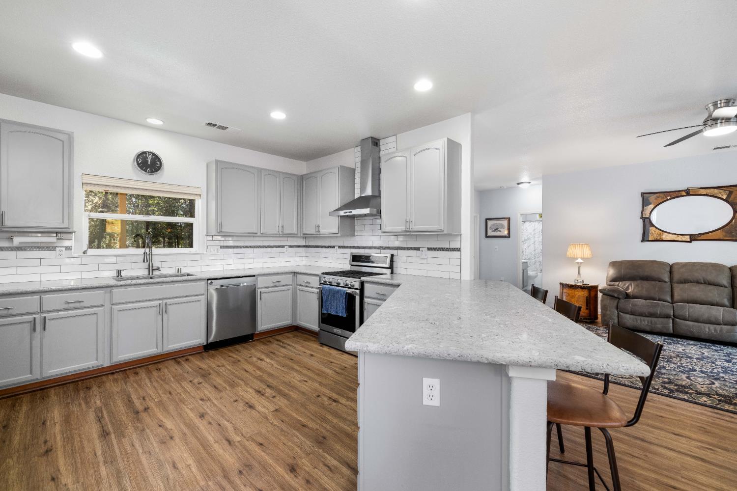 6843 Log Cabin Lane Placerville, CA 95667 - Photo 26 of 49 a kitchen with stainless steel appliances granite countertop wooden cabinets a sink dishwasher a stove and a refrigerator with wooden floor