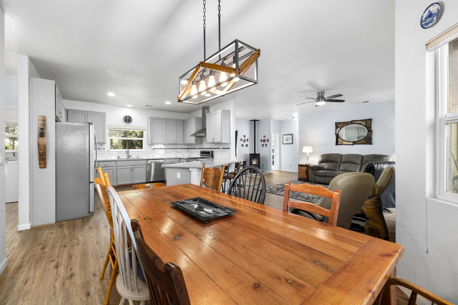 6843 Log Cabin Lane Placerville, CA 95667 - Photo 27 of 49 a kitchen with stainless steel appliances granite countertop a dining table chairs refrigerator and sink