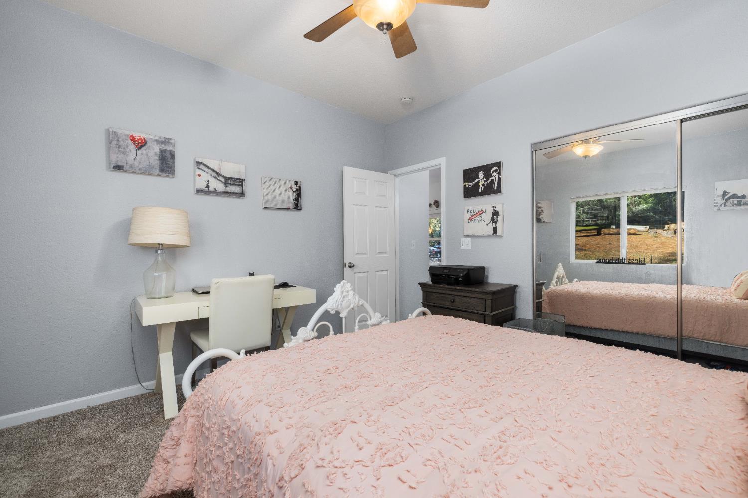 6843 Log Cabin Lane Placerville, CA 95667 - Photo 34 of 49 a bedroom with a bed and a chandelier