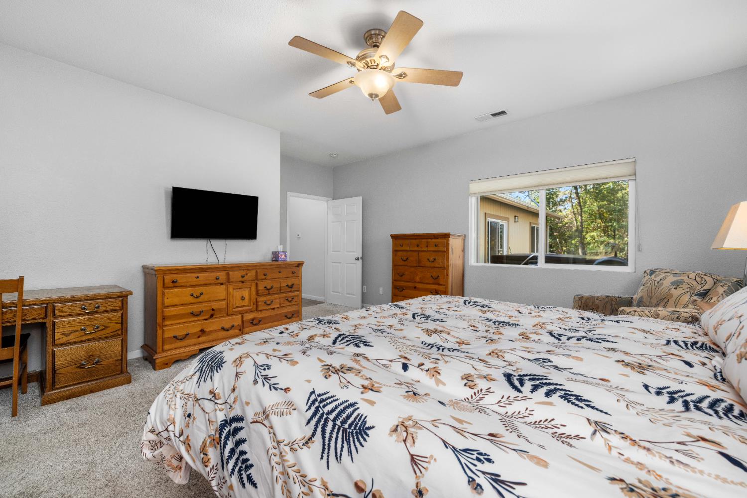 6843 Log Cabin Lane Placerville, CA 95667 - Photo 38 of 49 a bedroom with a bed and a flat screen tv on dresser