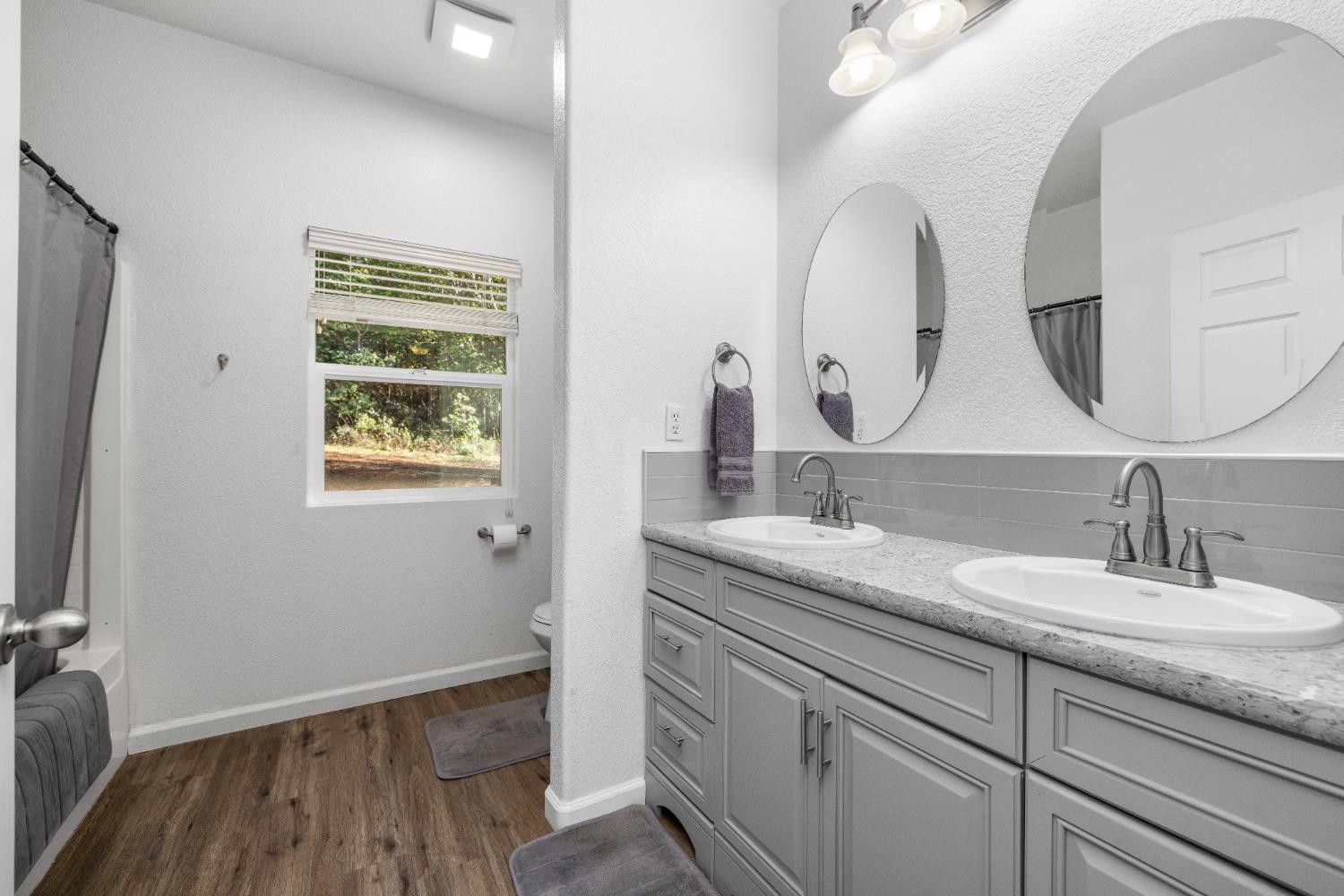 6843 Log Cabin Lane Placerville, CA 95667 - Photo 40 of 49 a bathroom with a double vanity sink and a mirror