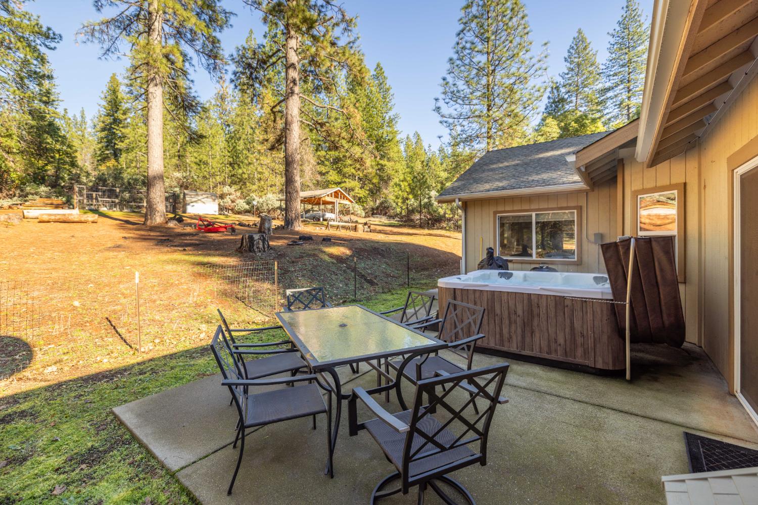 6843 Log Cabin Lane Placerville, CA 95667 - Photo 41 of 49 a view of a patio with table and chairs with wooden floor and fence