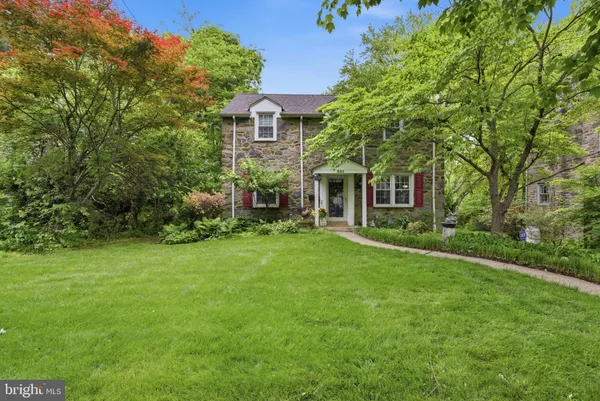 a front view of a house with plants and garden