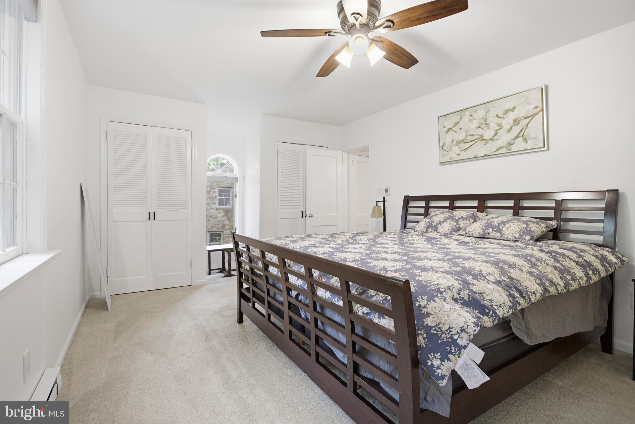 301 Riverview Road Swarthmore, PA 19081 - Photo 21 of 46 a bedroom with a large bed and a chandelier