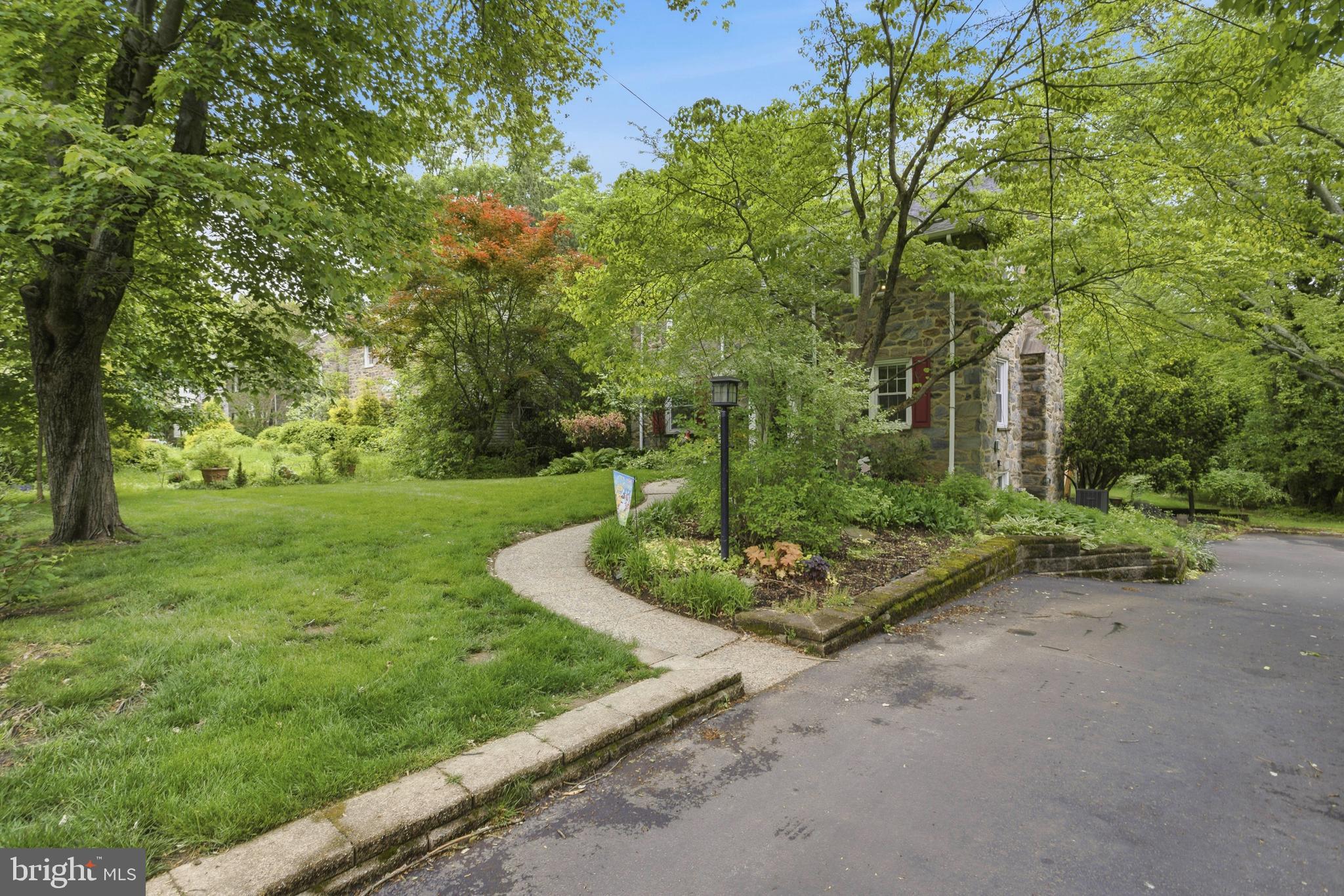 301 Riverview Road Swarthmore, PA 19081 - Photo 3 of 46 a view of a garden with large trees
