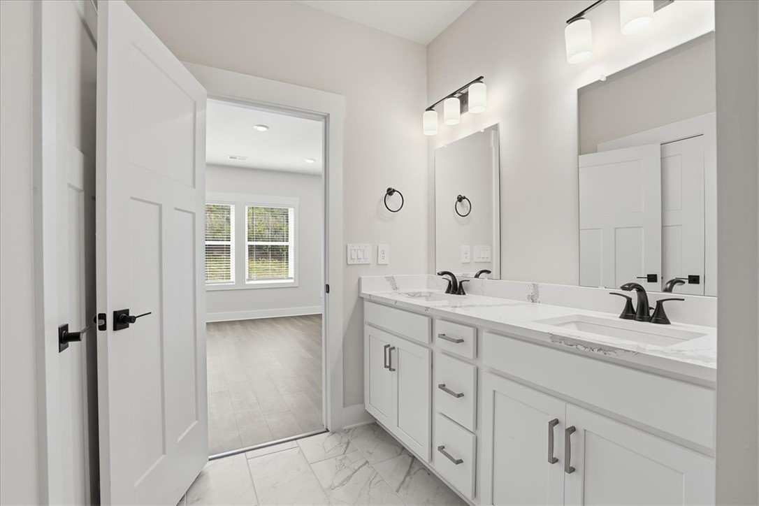 343 Allingham Road Piedmont, SC 29673 - Photo 23 of 37 Marble-patterned flooring and a spacious dual vanity define this bright bathroom.